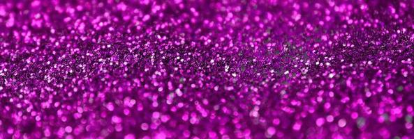 Pink decorative sequins. Background image with shiny bokeh lights from small elements photo