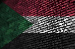 Sudan flag  is depicted on the screen with the program code. The concept of modern technology and site development photo