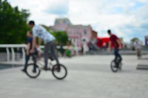 Defocused image of a lot of people with bmx bikes. Meeting of fans of extreme sports photo