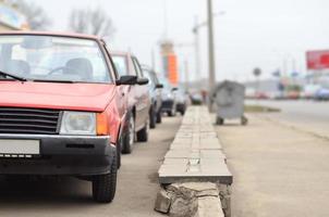 A side view of a car standing near a roadway photo