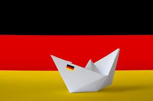 Germany flag depicted on paper origami ship closeup. Handmade arts concept photo