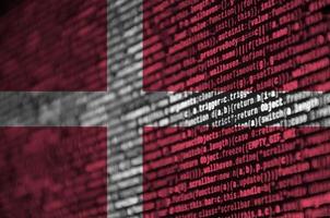 Denmark flag  is depicted on the screen with the program code. The concept of modern technology and site development photo