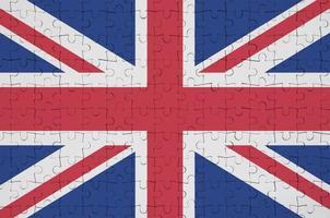 Great britain flag  is depicted on a folded puzzle photo