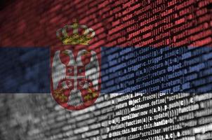 Serbia flag  is depicted on the screen with the program code. The concept of modern technology and site development photo