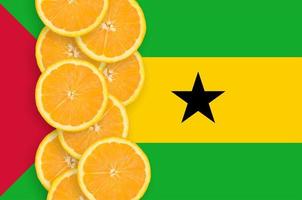 Sao Tome and Principe flag and citrus fruit slices vertical row photo