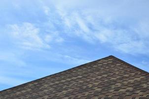 The roof covered with a modern flat bituminous waterproof coating under a blue sky photo