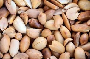 Peanut. A lot of small yellow nuts without peel. Background texture photo