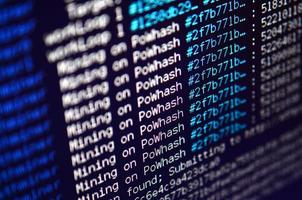 Macro snapshot of the program interface for crypto currency mining on the monitor of an office computer. The concept of mining bitcoins. The flow of information strings and data photo