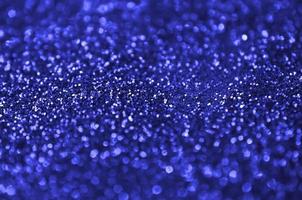 Blue decorative sequins. Background image with shiny bokeh lights from small elements photo