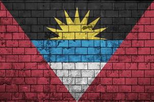 Antigua and Barbuda flag is painted onto an old brick wall photo