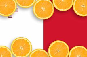 Malta flag  in citrus fruit slices horizontal frame photo