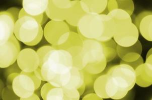 Bokeh effect golden yellow defocused light background. Christmas Lights Concept photo