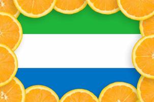 Sierra Leone flag  in fresh citrus fruit slices frame photo