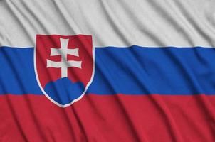 Slovakia flag  is depicted on a sports cloth fabric with many folds. Sport team banner photo