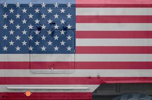 United States of America flag depicted on side part of military armored truck closeup. Army forces conceptual background photo