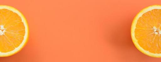 Top view of a several orange fruit slices on bright background in orange color. A saturated citrus texture image photo
