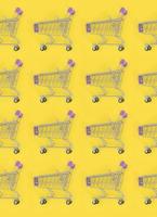 Shopping addiction, shopping lover or shopaholic concept. Many small empty shopping carts perform a pattern on a pastel colored paper background. Flat lay composition, top view photo