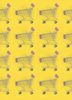 Shopping addiction, shopping lover or shopaholic concept. Many small empty shopping carts perform a pattern on a pastel colored paper background. Flat lay composition, top view photo