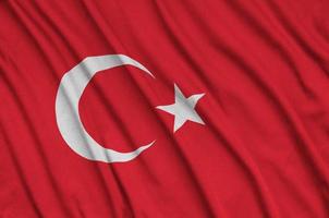 Turkey flag  is depicted on a sports cloth fabric with many folds. Sport team banner photo