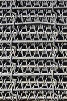 Metal multilayered thick grid of black color. Composite texture photo