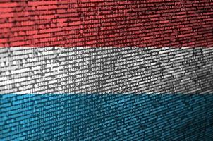 Luxembourg flag  is depicted on the screen with the program code. The concept of modern technology and site development photo