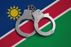 Namibia flag  and police handcuffs. The concept of observance of the law in the country and protection from crime photo