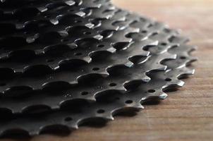 Rear cassette sprocket from a mountain bike lying on a wooden table in a bike shop photo