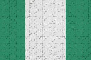 Nigeria flag  is depicted on a folded puzzle photo