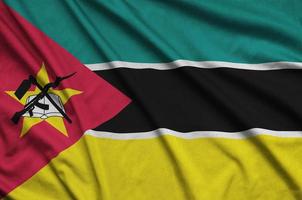 Mozambique flag  is depicted on a sports cloth fabric with many folds. Sport team banner photo