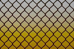 Texture of an old and rusty metal mesh on a neutral colored background photo