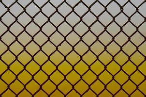 Texture of an old and rusty metal mesh on a neutral colored background photo