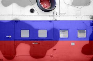 Russia flag depicted on side part of military armored helicopter closeup. Army forces aircraft conceptual background photo