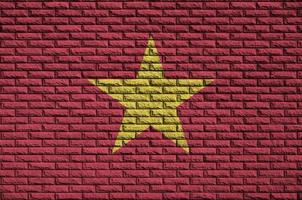 Vietnam flag is painted onto an old brick wall photo