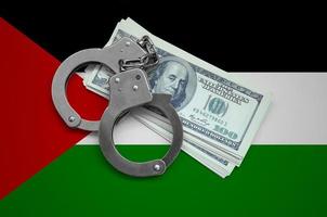 Western Sahara flag  with handcuffs and a bundle of dollars. Currency corruption in the country. Financial crimes photo