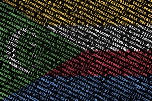 Comoros flag  is depicted on the screen with the program code. The concept of modern technology and site development photo