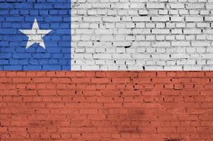 Chile flag is painted onto an old brick wall photo