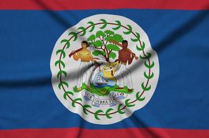 Belize flag  is depicted on a sports cloth fabric with many folds. Sport team banner photo