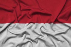 Indonesia flag  is depicted on a sports cloth fabric with many folds. Sport team banner photo