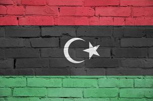 Libya flag is painted onto an old brick wall photo