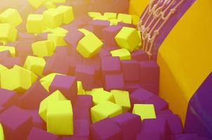 Many colorful soft blocks in a kids' ballpit at a playground photo