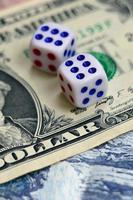 White dice are on a dollar bill of US dollars. The concept of gambling with rates in monetary units photo