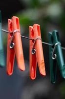 Clothespins on a rope hanging outside house and apple tree photo