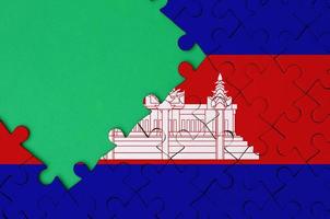 Cambodia flag  is depicted on a completed jigsaw puzzle with free green copy space on the left side photo