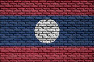 Laos flag is painted onto an old brick wall photo