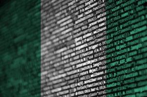 Nigeria flag  is depicted on the screen with the program code. The concept of modern technology and site development photo