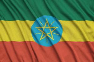 Ethiopia flag  is depicted on a sports cloth fabric with many folds. Sport team banner photo