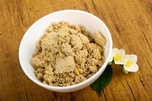 Halva in a bowl on wooden background photo