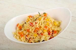 Mexican rice in a bowl on wooden background photo