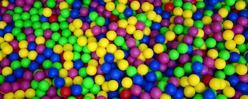 muchas bolas de plástico de colores en una piscina para niños en un parque infantil. patrón de primer plano foto