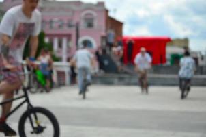 Defocused image of a lot of people with bmx bikes. Meeting of fans of extreme sports photo